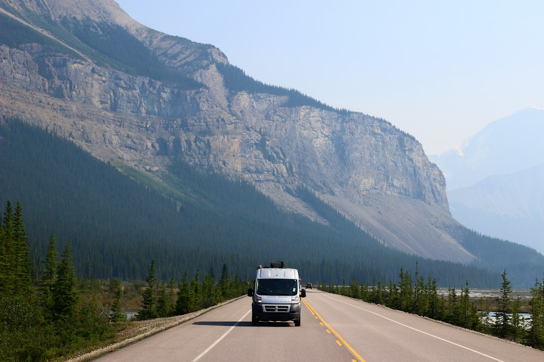 Delivery van travelling on a mountain road, illustrating an urgent Edmonton to Fort McKay courier movement.
